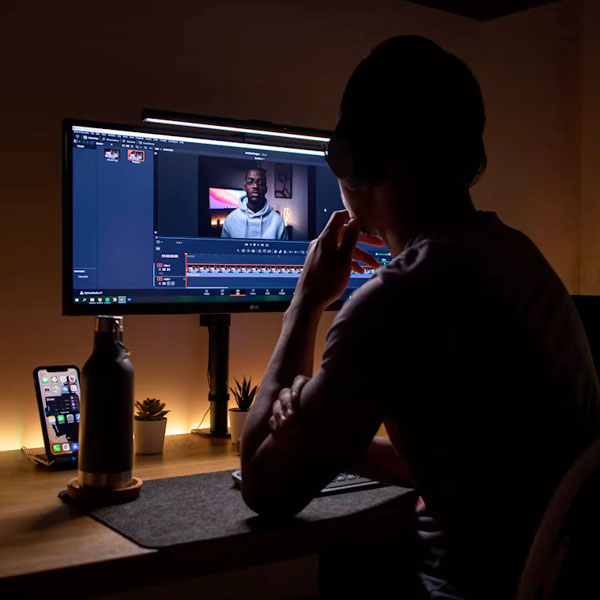 person editing video on computer